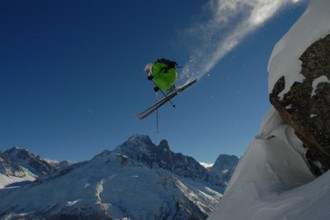 Skier takes on a sizeable rock drop in Chamonix for the Freeride World Tour