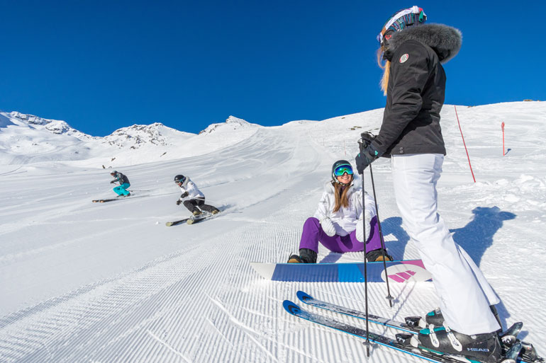Intermediate skiers and boarders in Val Thorens
