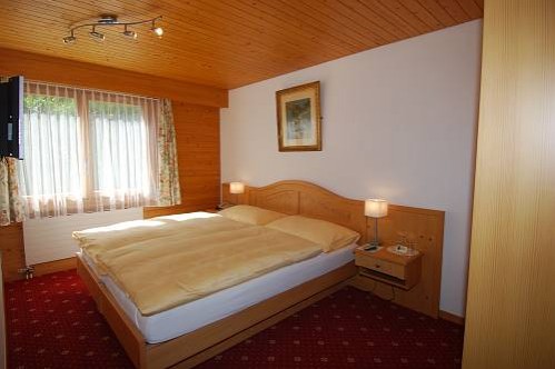 The Bedroom of a Family Suite in the Hotel Eiger - Murren