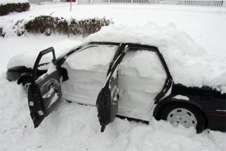 Car buried in snow and full of snow